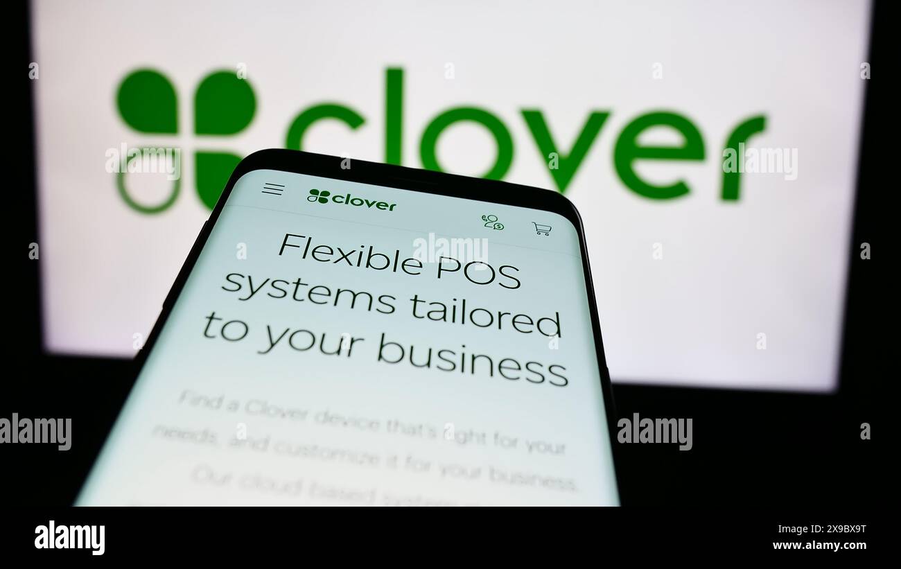 Smartphone con pagina Web della società statunitense Clover Network Inc. Di fronte al logo aziendale. Mettere a fuoco in alto a sinistra sul display del telefono. Foto Stock