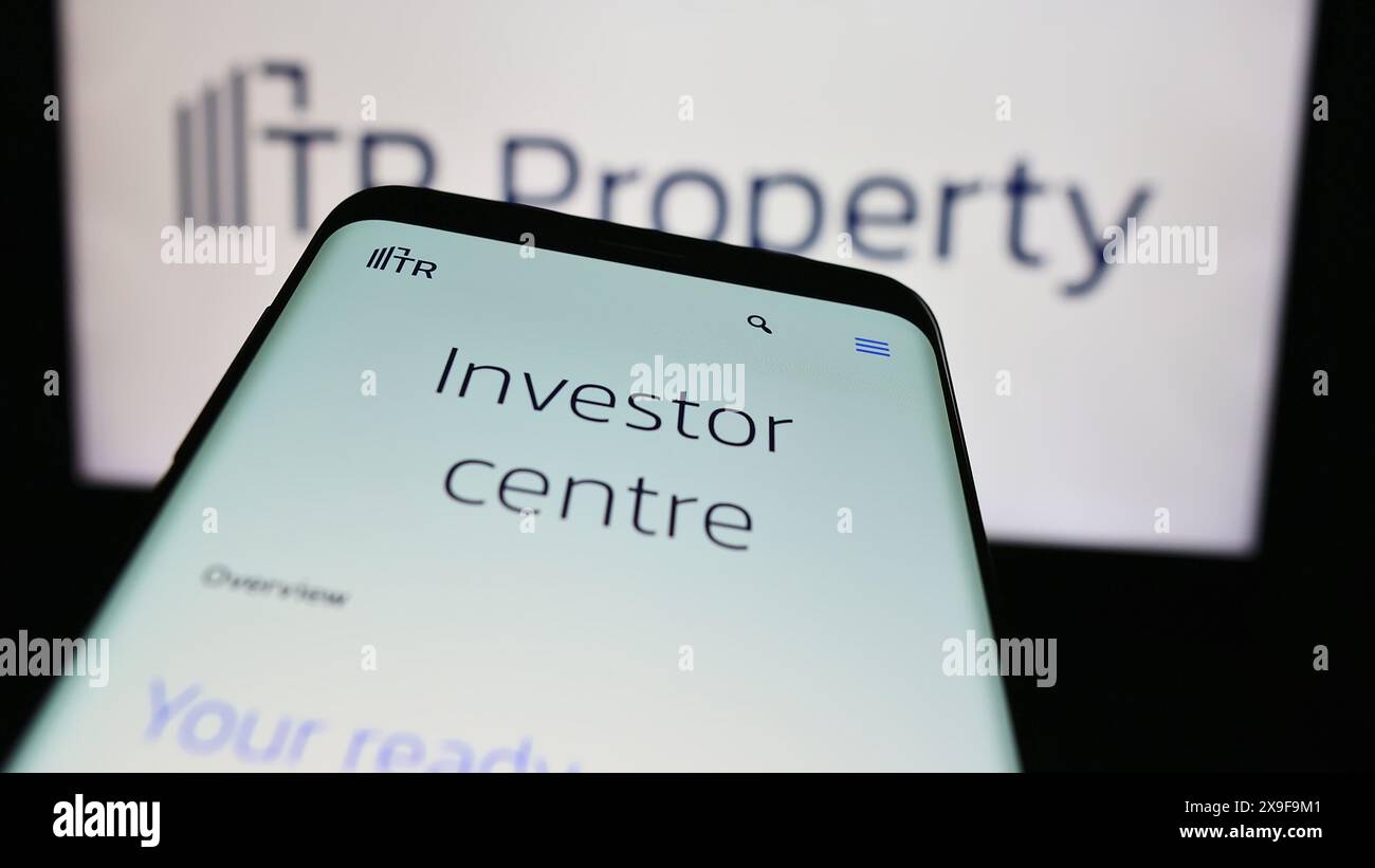 Smartphone con sito web della società britannica TR Property Investment Trust plc davanti al logo aziendale. Mettere a fuoco in alto a sinistra sul display del telefono. Foto Stock