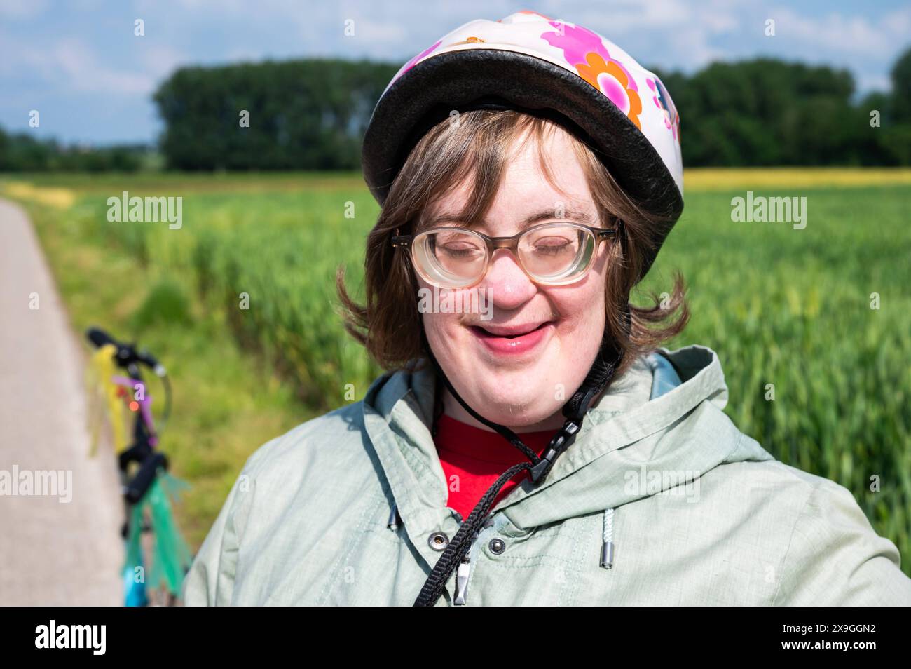 Ritratto all'aperto di una donna di 41 anni con la sindrome di Down, occhi chiusi, Tienen, Fiandre, Belgio. Modello rilasciato. Foto Stock