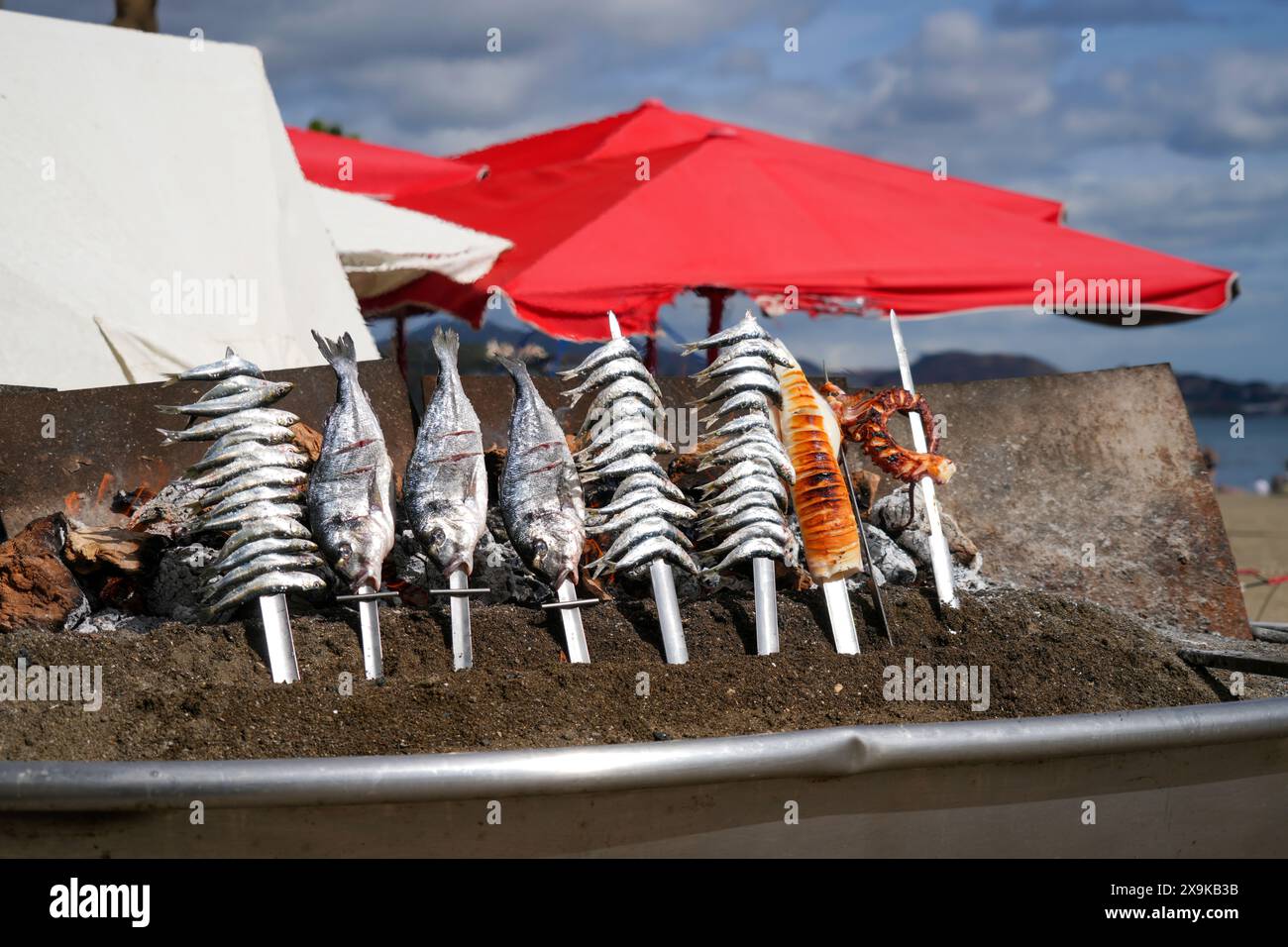 Tradizione Málaga, espetos (sardine su spiedini) su un barbecue a fiamma aperta, area barbecue sulla spiaggia di Malagueta a Malaga, Costa del Sol, Spagna. Niente persone. Foto Stock