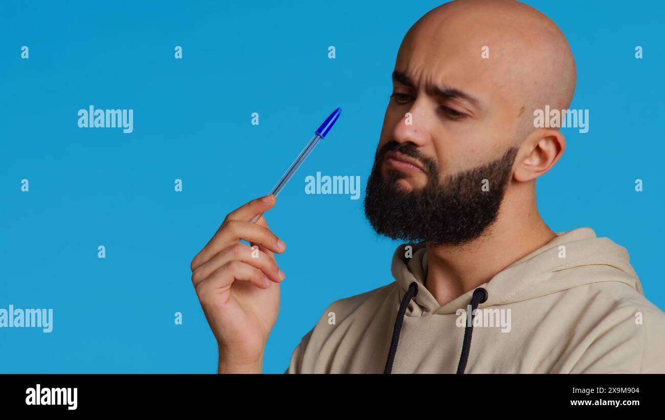 Persona araba che pensa alla soluzione del problema, agisce penalmente e rifletta le decisioni di fronte alla telecamera. Tizio del Medio Oriente che cerca di trovare nuove idee innovative. Telecamera 2. Foto Stock