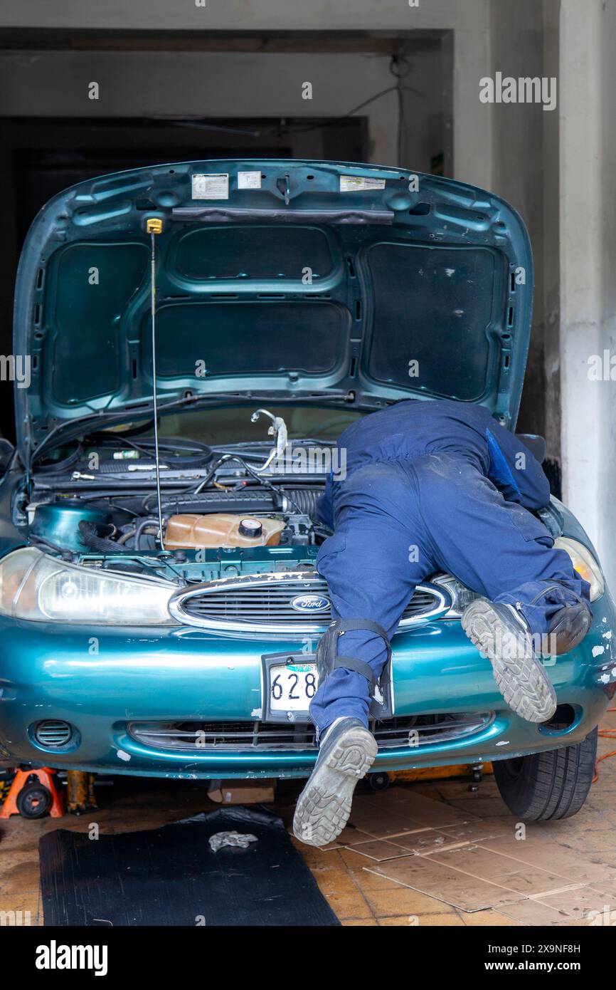 Uomo che lavora su Car a città del Messico, Messico Foto Stock