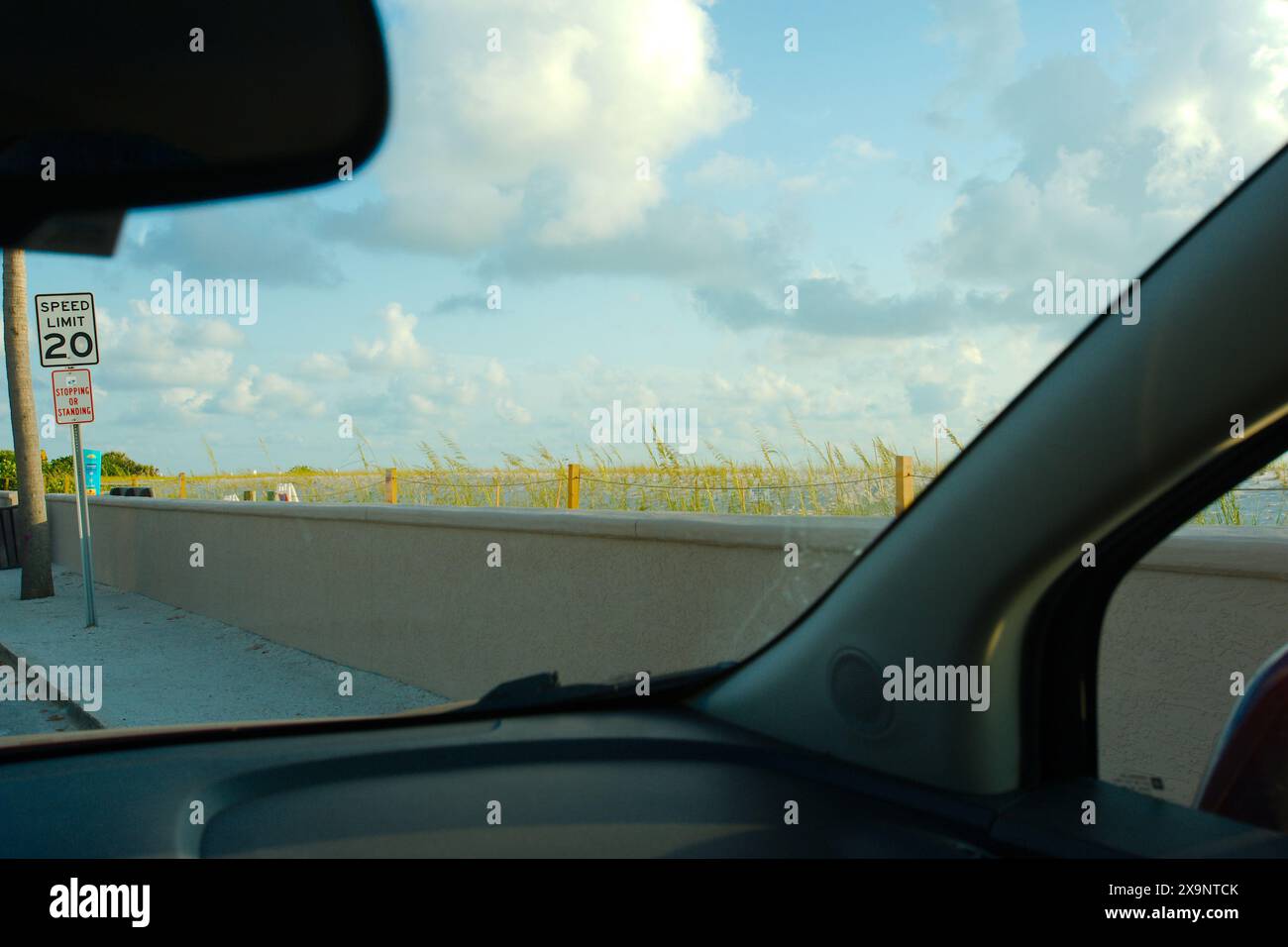 Ampia vista della spiaggia di Pass-a-Grille a St. Pete Beach, Florida, guardando verso sud dall'interno dell'auto sopra l'avena verde e la sabbia. Onde nell'acqua, Foto Stock