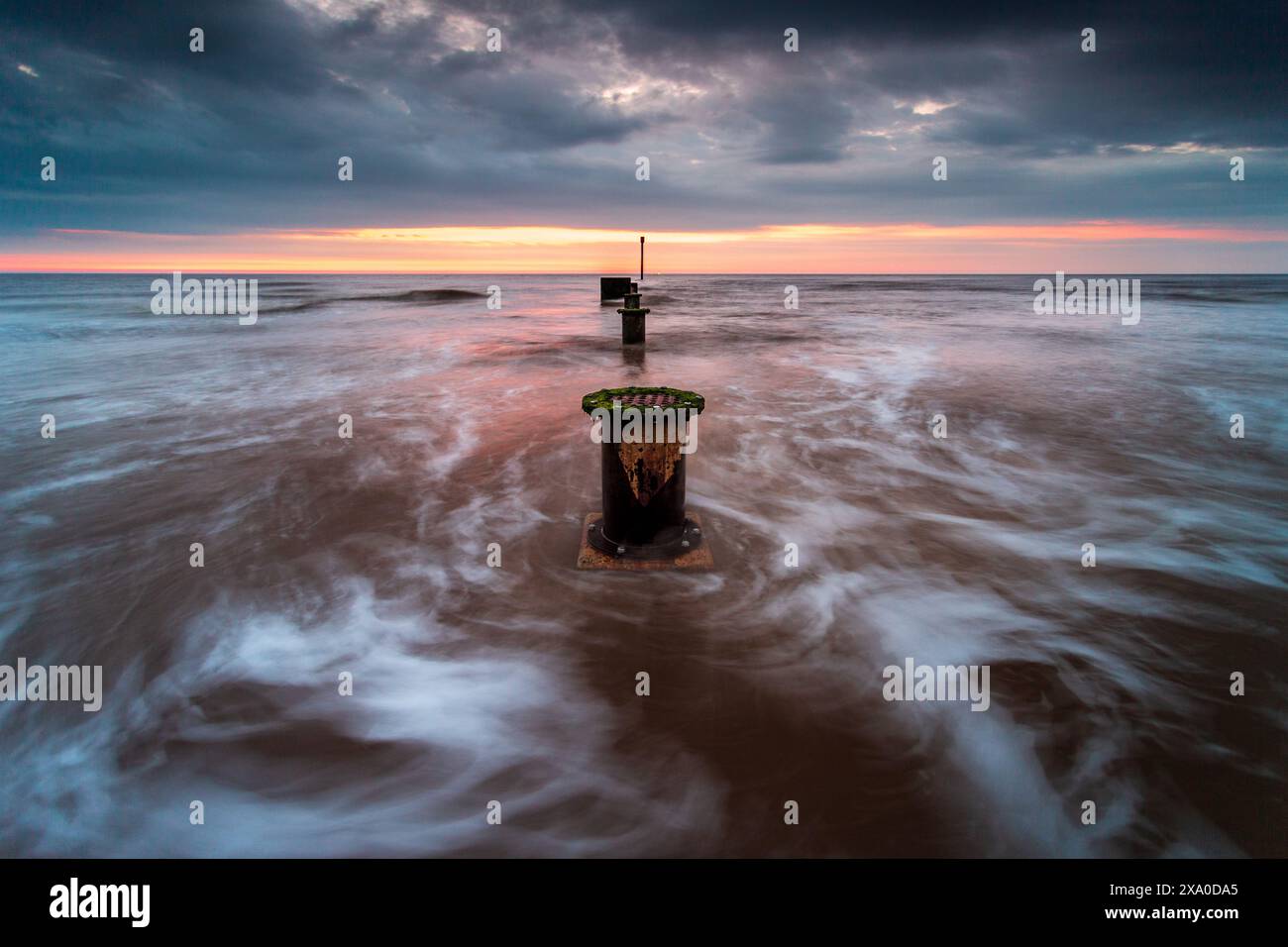 Il sole tramonta sull'oceano sereno. Foto Stock