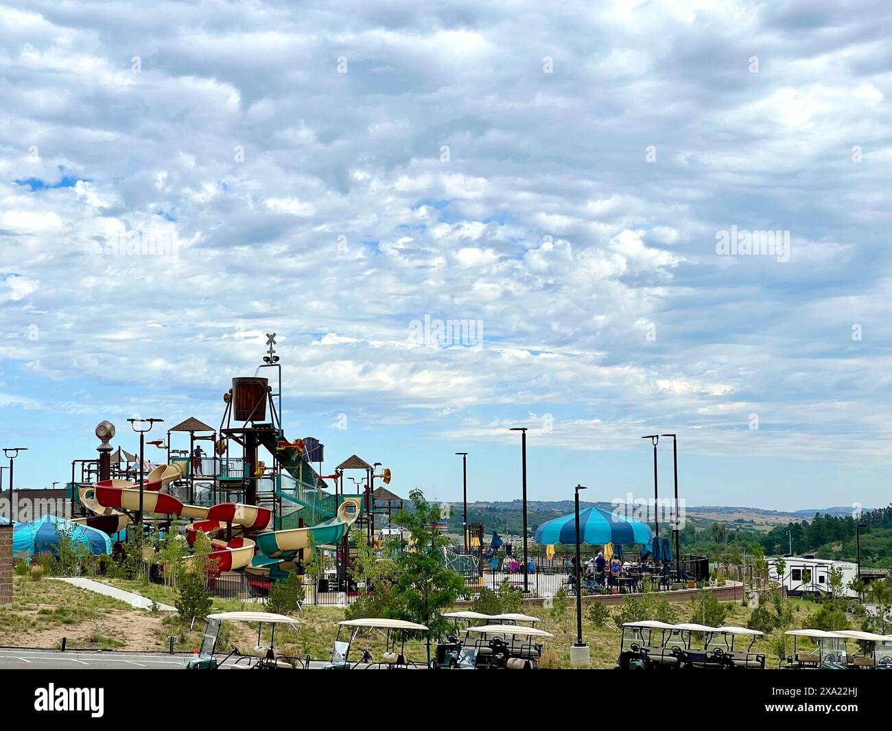 Auto parcheggiate in strada vicino a un parco giochi Foto Stock