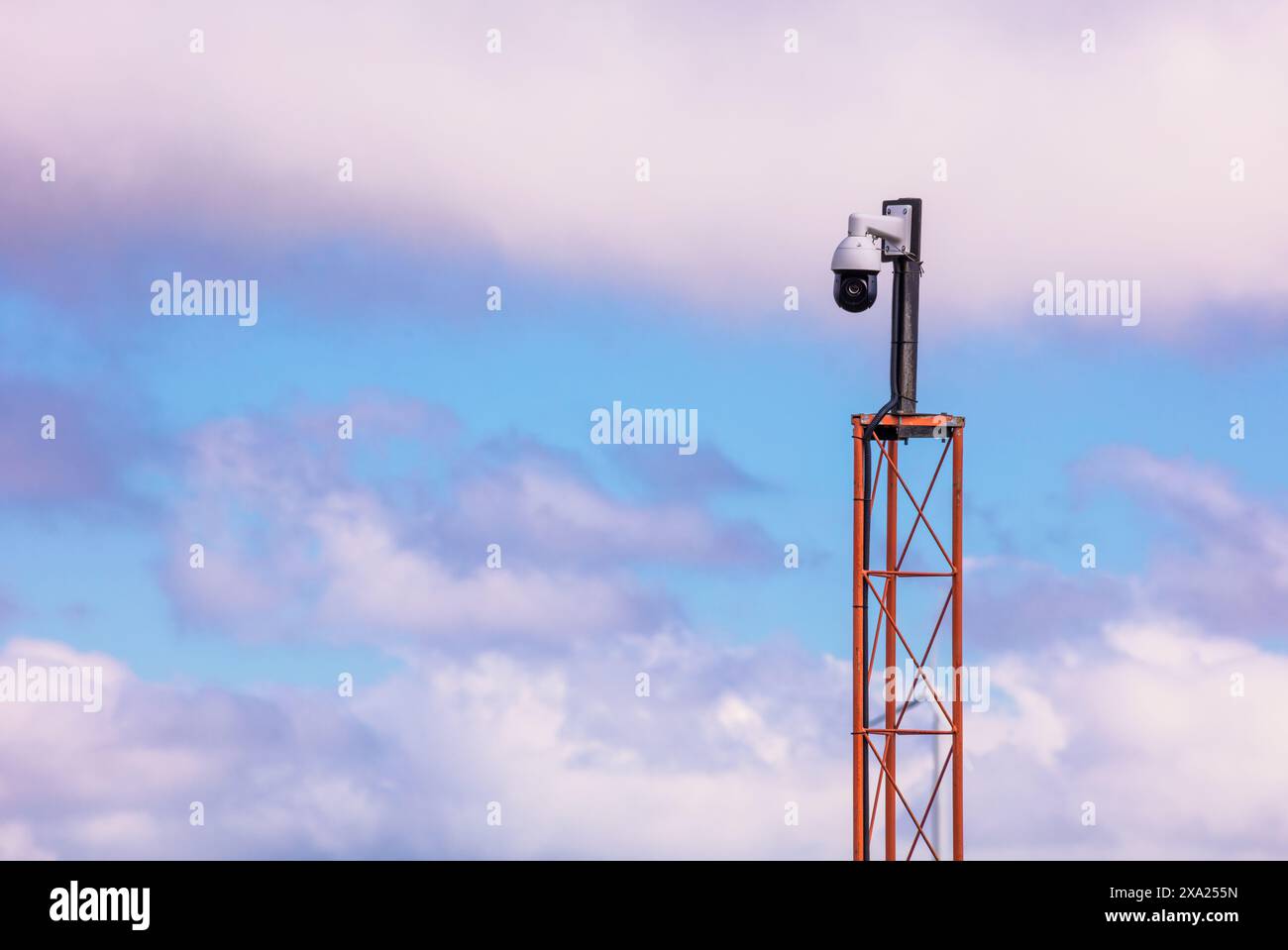 Struttura alta con telecamera sotto il cielo coperto Foto Stock