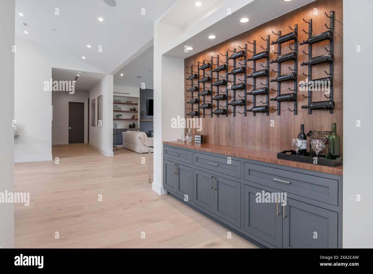 Gli scaffali riempiti di bottiglie contro un muro in una nuova casa moderna di Los Angeles Foto Stock