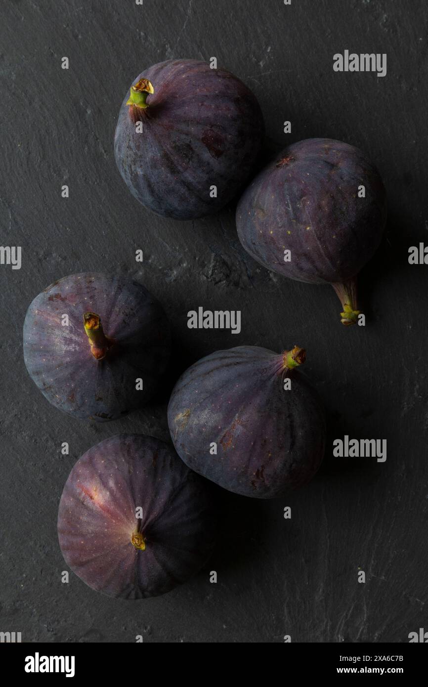 foto ravvicinata del piano portapaziente di frutti di fico su sfondo scuro, fotografie di natura morta con cibo basso Foto Stock