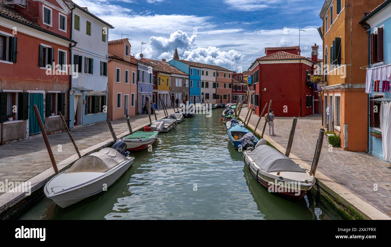 Piccole barche ormeggiate sul canale accanto a edifici colorati Foto Stock