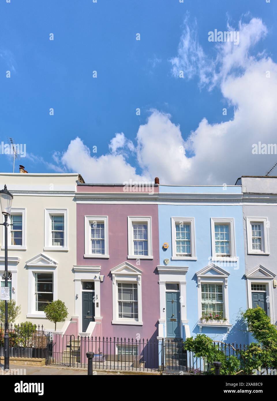 Alloggio a schiera dipinto in colori pastello su Kensington Place, Kensington, Londra, Inghilterra. Foto Stock