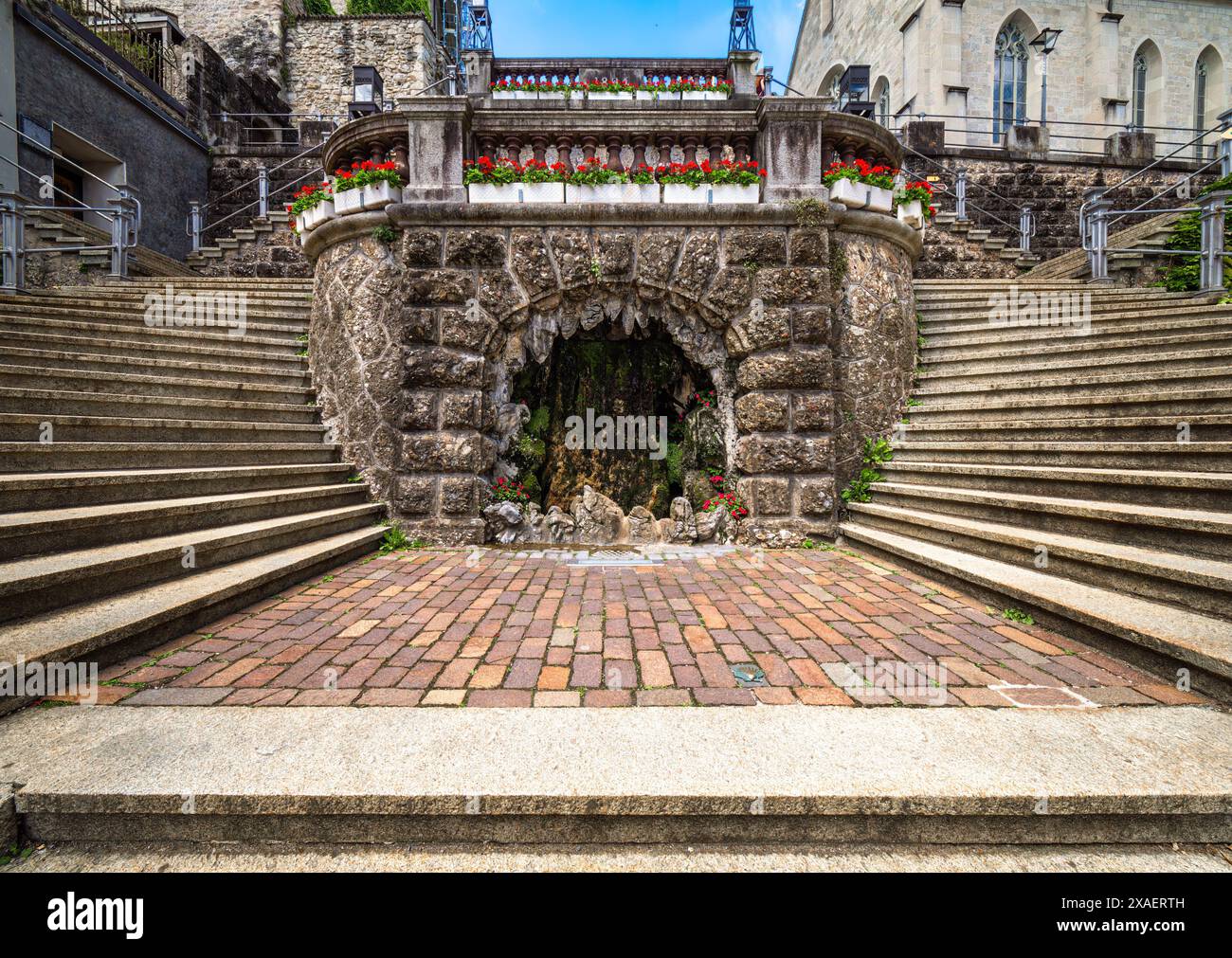 Storica grotta di pietra con scalinata decorata con fiori a Rapperswil. Foto Stock