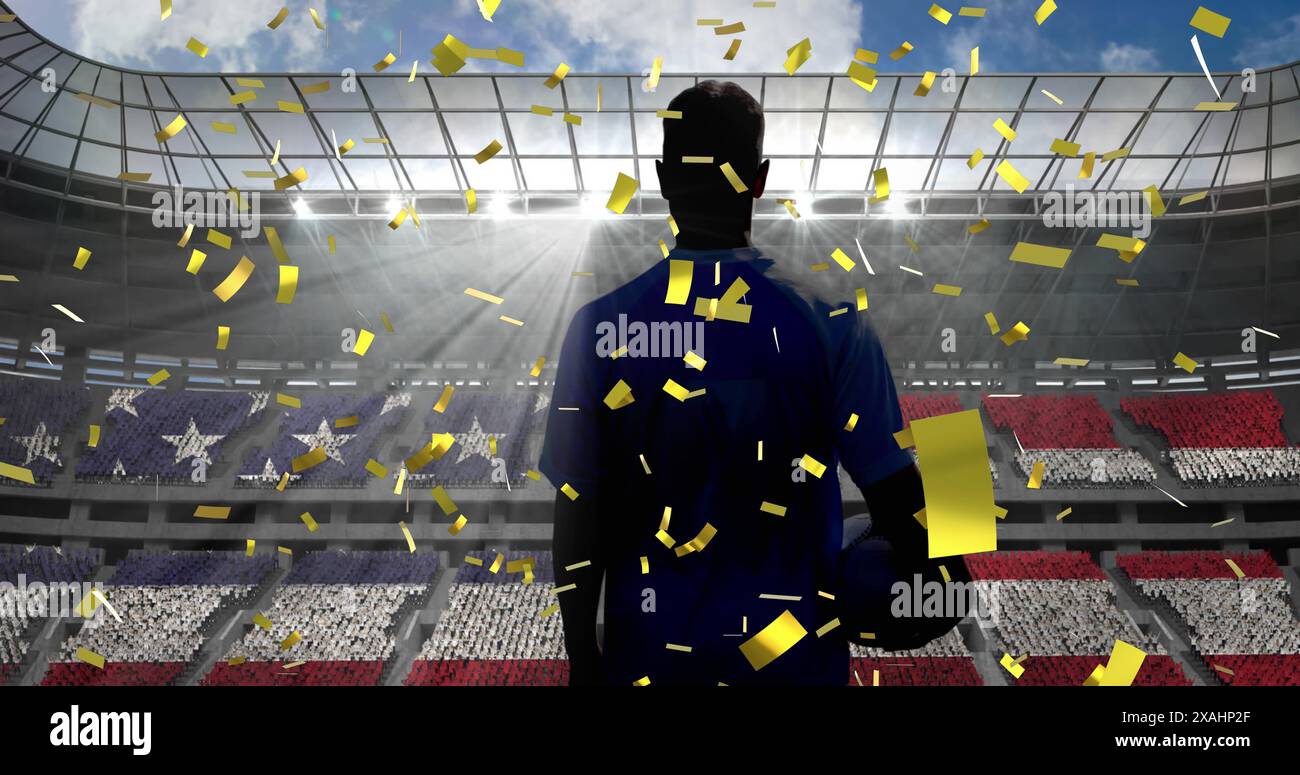 Coriandoli dorati sul retro del giocatore di rugby che tiene la palla di rugby contro lo stadio sportivo Foto Stock