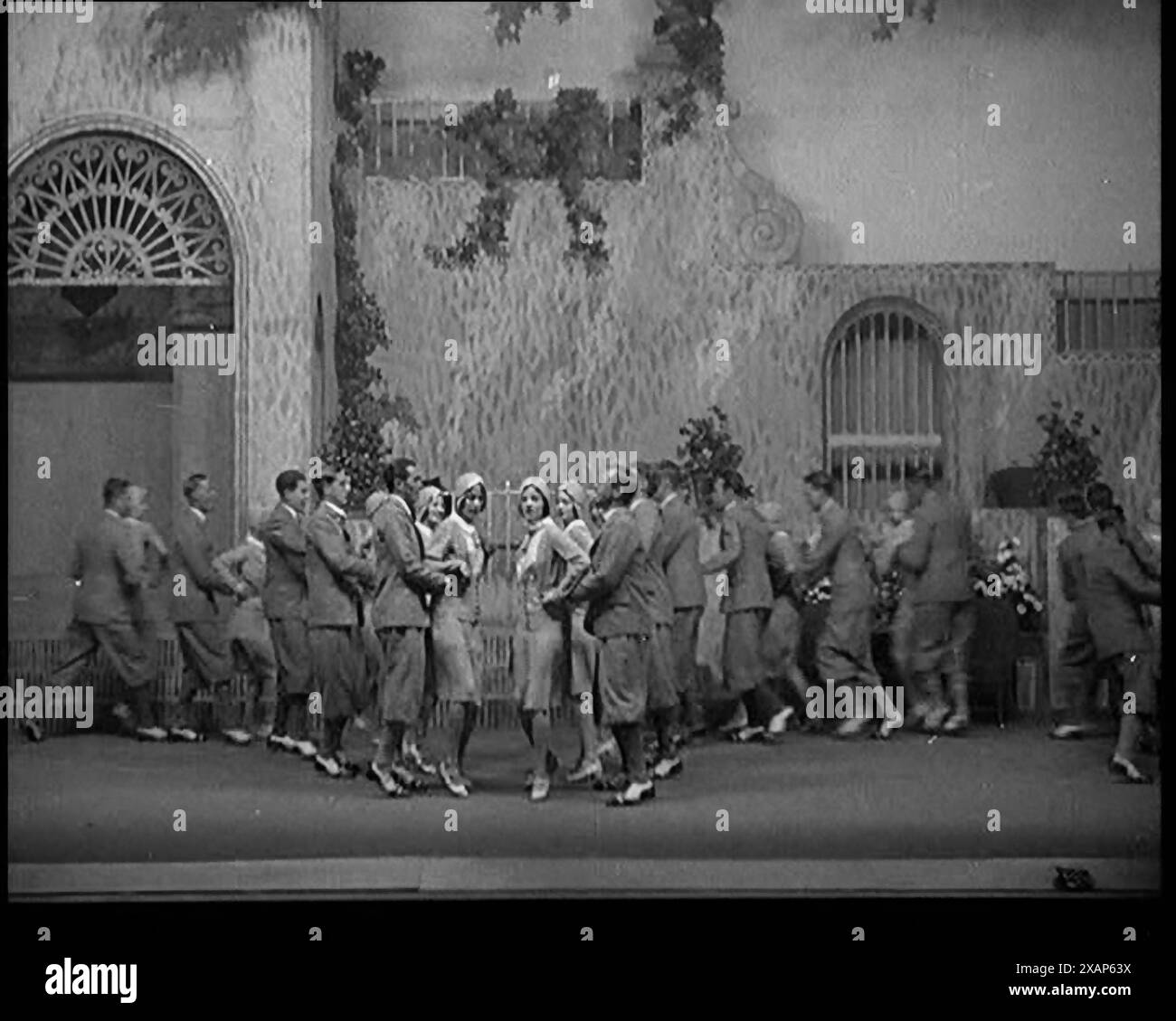 Scena di uno spettacolo teatrale: Civili uomini e donne ballano su un palco in una routine con molti ascensori e molti High Kicks, 1929. Da "Time to Remember - 1929 The Time of the House at Bognor" - Reel 4; un documentario sul mondo nel 1929. Malattia di re Giorgio V &amp; depressione economica. Foto Stock