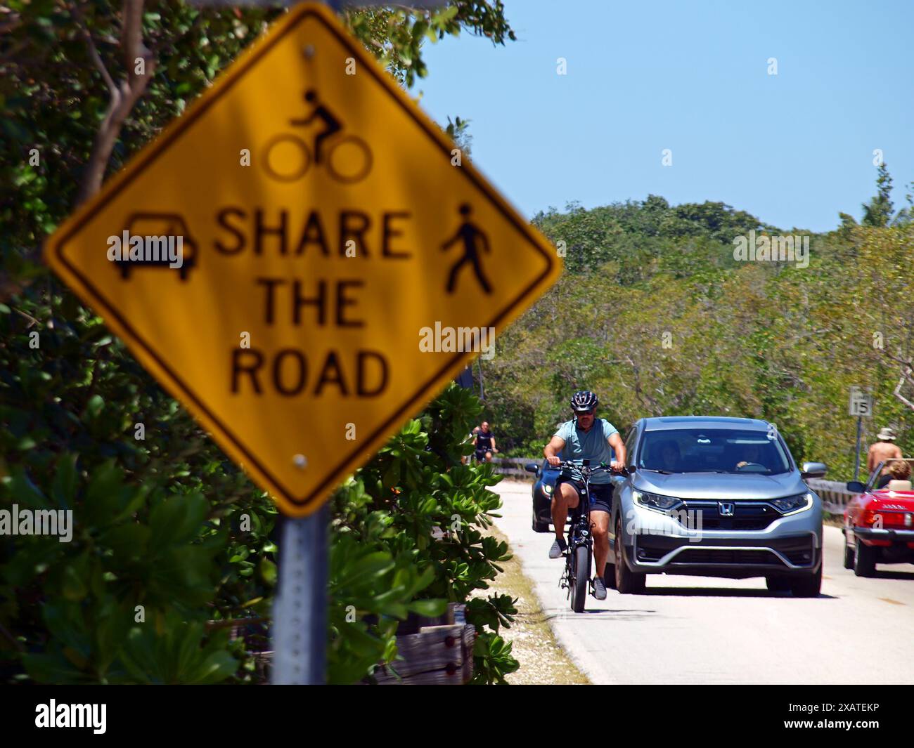 Miami, Florida, Stati Uniti - 13 aprile 2024: Cartello segnaletico e biciclette che condividono una strada con le auto. Solo per uso editoriale. Foto Stock