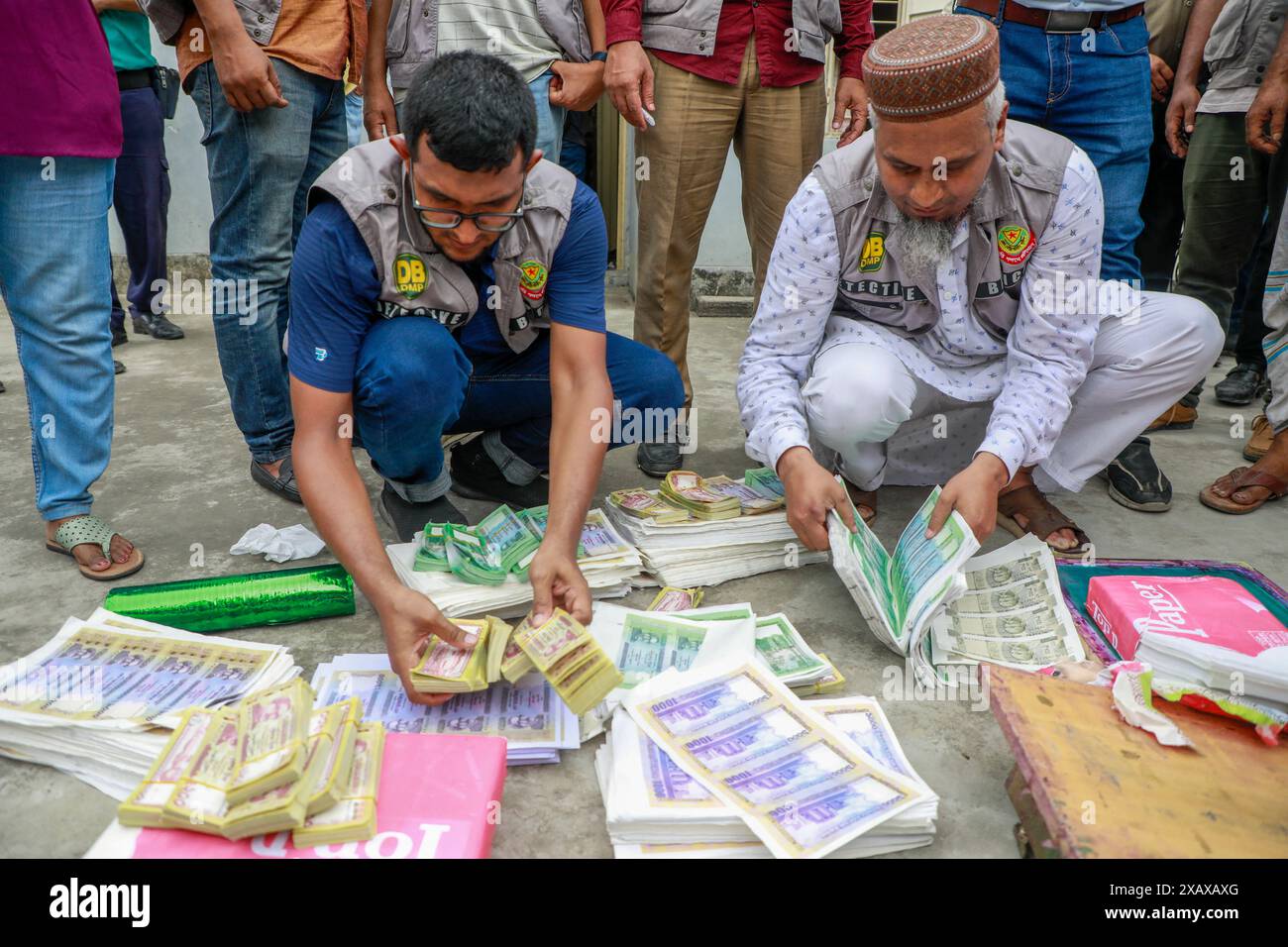 Il detective Branch della polizia di sabato ha arrestato cinque persone, tra cui la mente, Liakat Hossain Zakir, e quattro donne con banconote false per un valore di 1,5 TK in una fabbrica di banconote false nella zona di Kadamtali, nella capitale Dhaka, Bangladesh, 8 giugno 2024. Una squadra di DB della Lalbagh Division ha fatto irruzione nella fabbrica di valuta falsa in una casa dalle 9.00 alle 12.00. I funzionari DEL DB hanno dichiarato di aver recuperato banconote false del valore di 1,5 TK e materiali per la fabbricazione di monete false TK 3 Crore da due case, tra cui carte e panni speciali, colori speciali, quattro computer portatili, quattro stampanti, Foto Stock