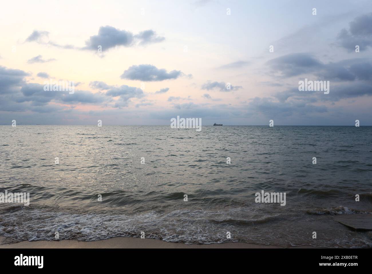 Lungo la riva del Mar Nero, la sera il sole stava per tramontare e c'erano nuvole nere tinto di arancio. Foto Stock