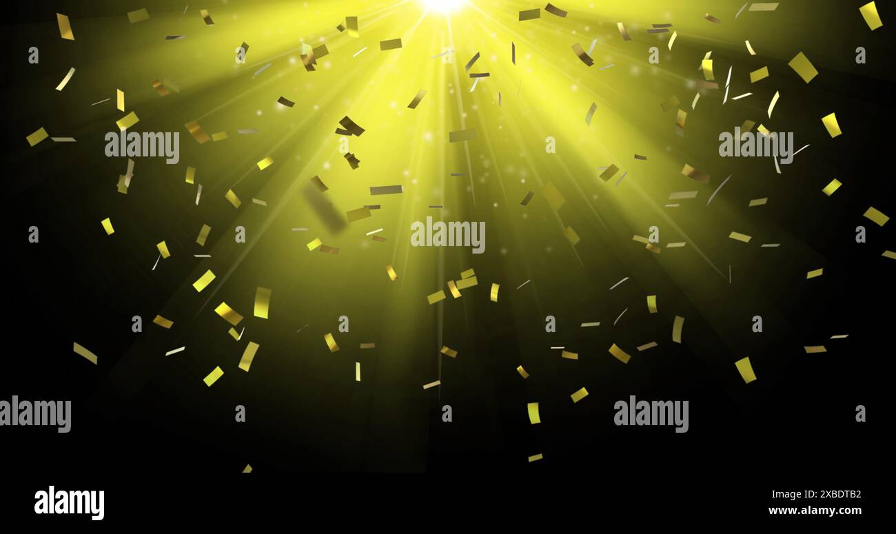 Immagine di coriandoli che cadono sulla luce gialla su sfondo nero Foto Stock
