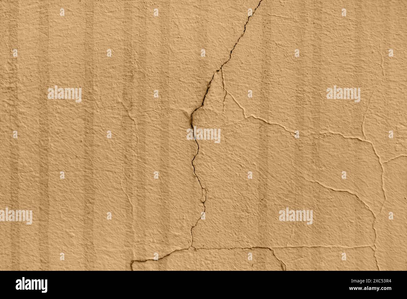 Uno stato di carico interno che ha portato a danni al muro, espresso sotto forma di crepe apparsa. Perdite di liquido verticali scure, probabilmente la parte esterna Foto Stock