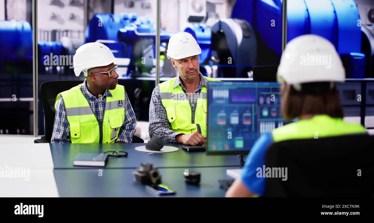 Formazione degli operatori presso l'impianto di produzione di energia elettrica. Gruppo di dipendenti diversificato Foto Stock
