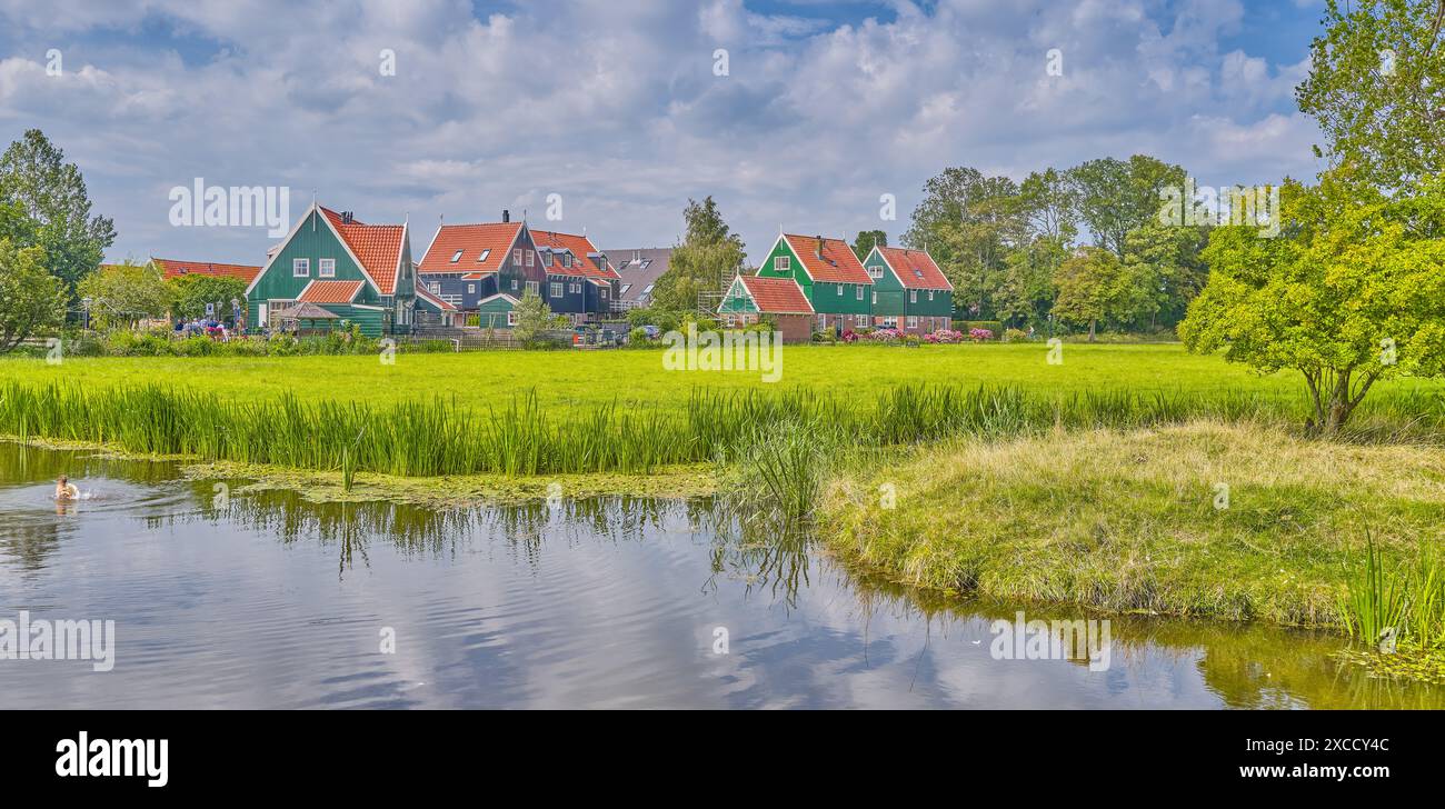 Marken, Olanda, le case tradizionali del villaggio tra campi coltivati e canali Foto Stock