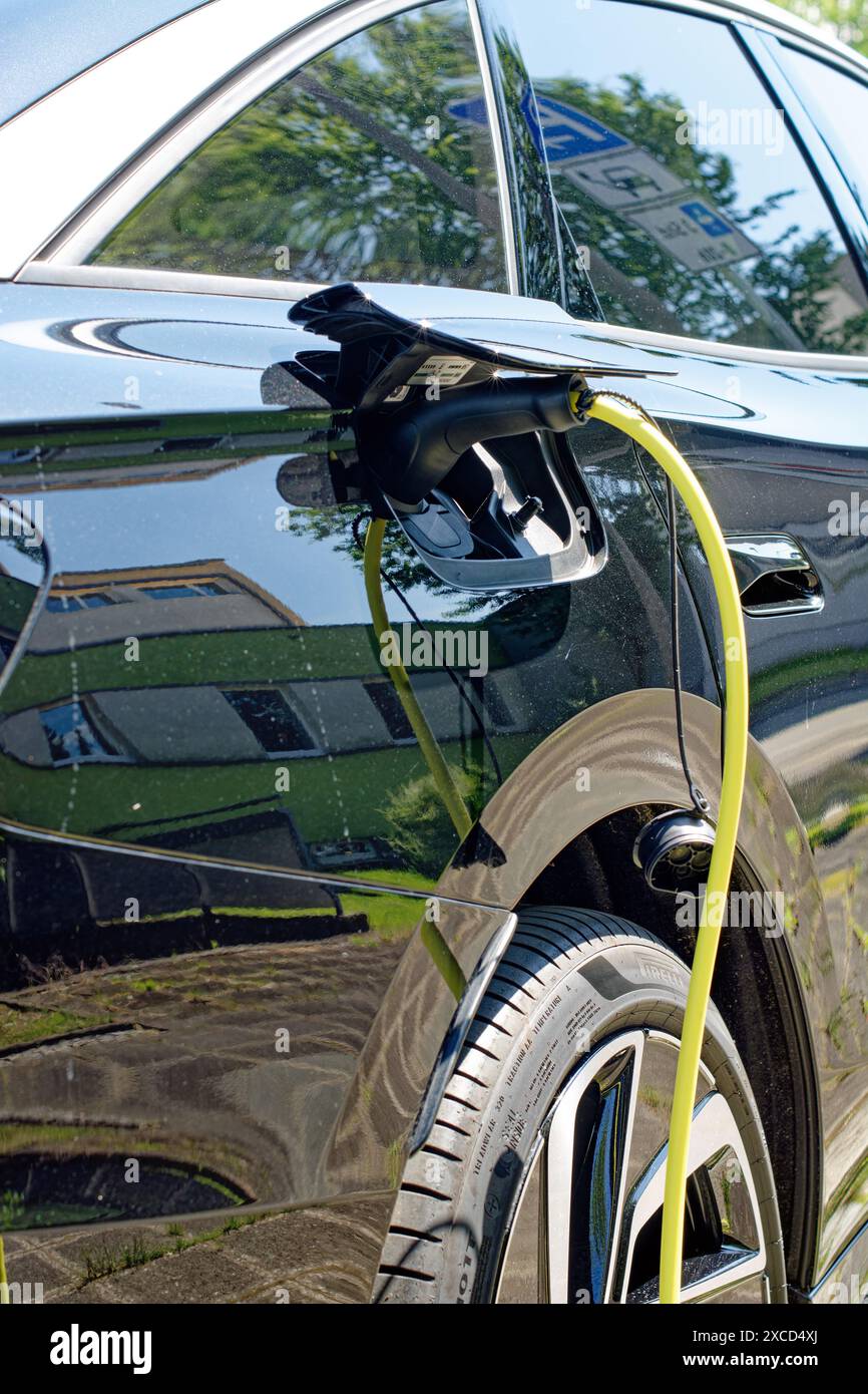 L'auto elettrica è in carica, primo piano del cavo collegato Foto Stock