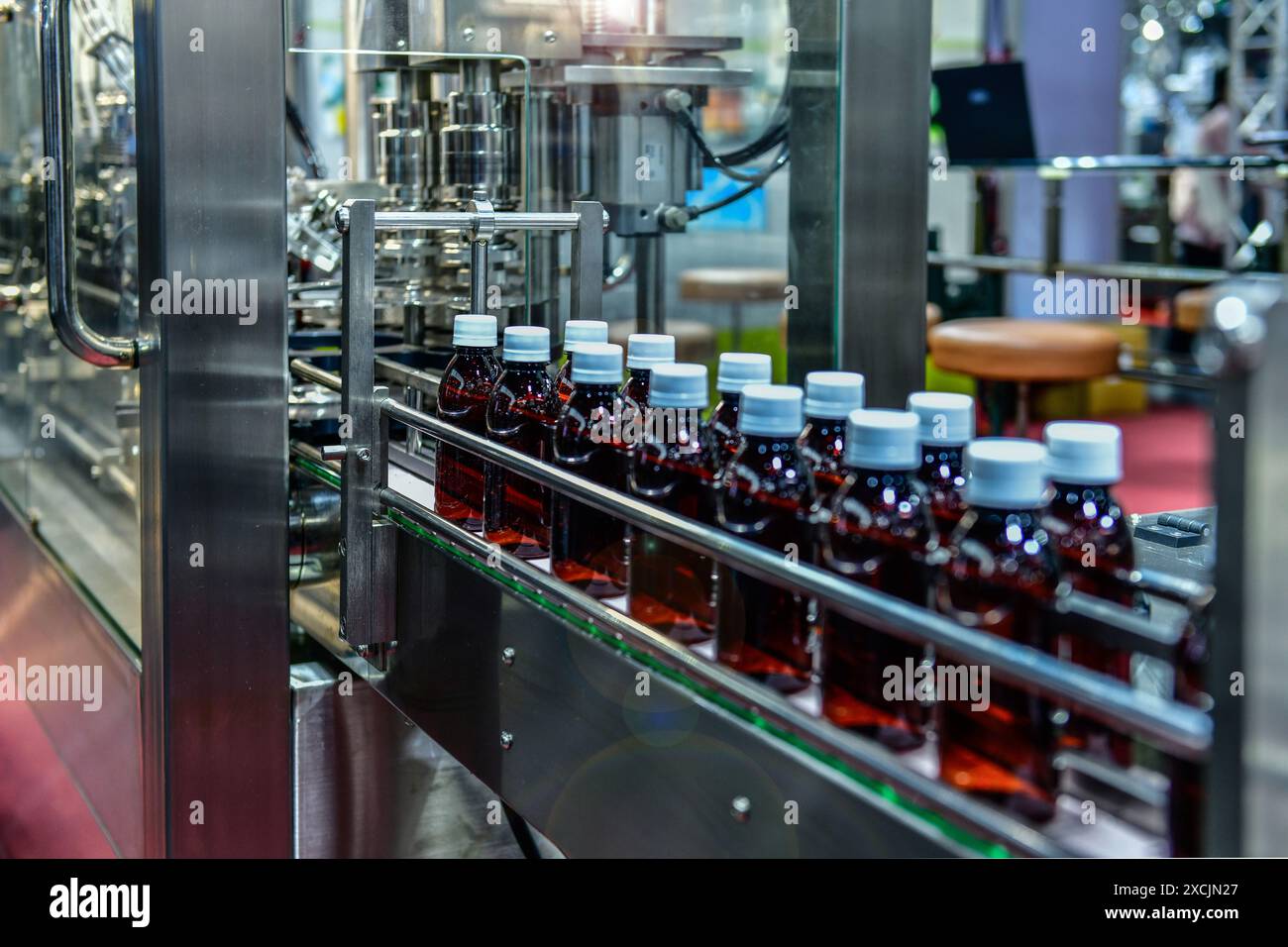 Bottiglie di vetro in un nastro trasportatore su un sistema automatico di alta qualità nella linea di produzione di fabbrica Foto Stock