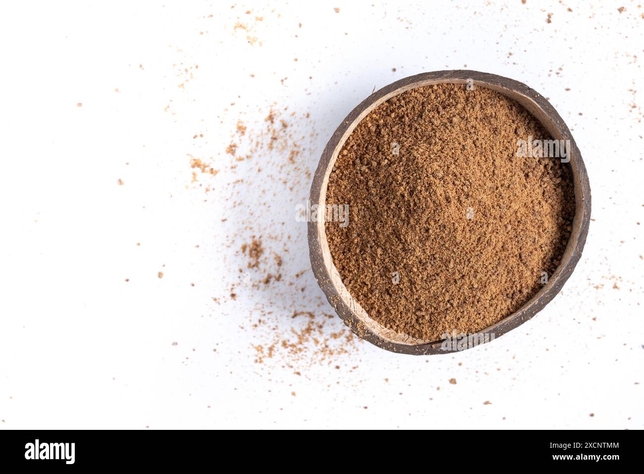 Zucchero di palma di cocco in un recipiente di cocco isolato su fondo bianco Foto Stock