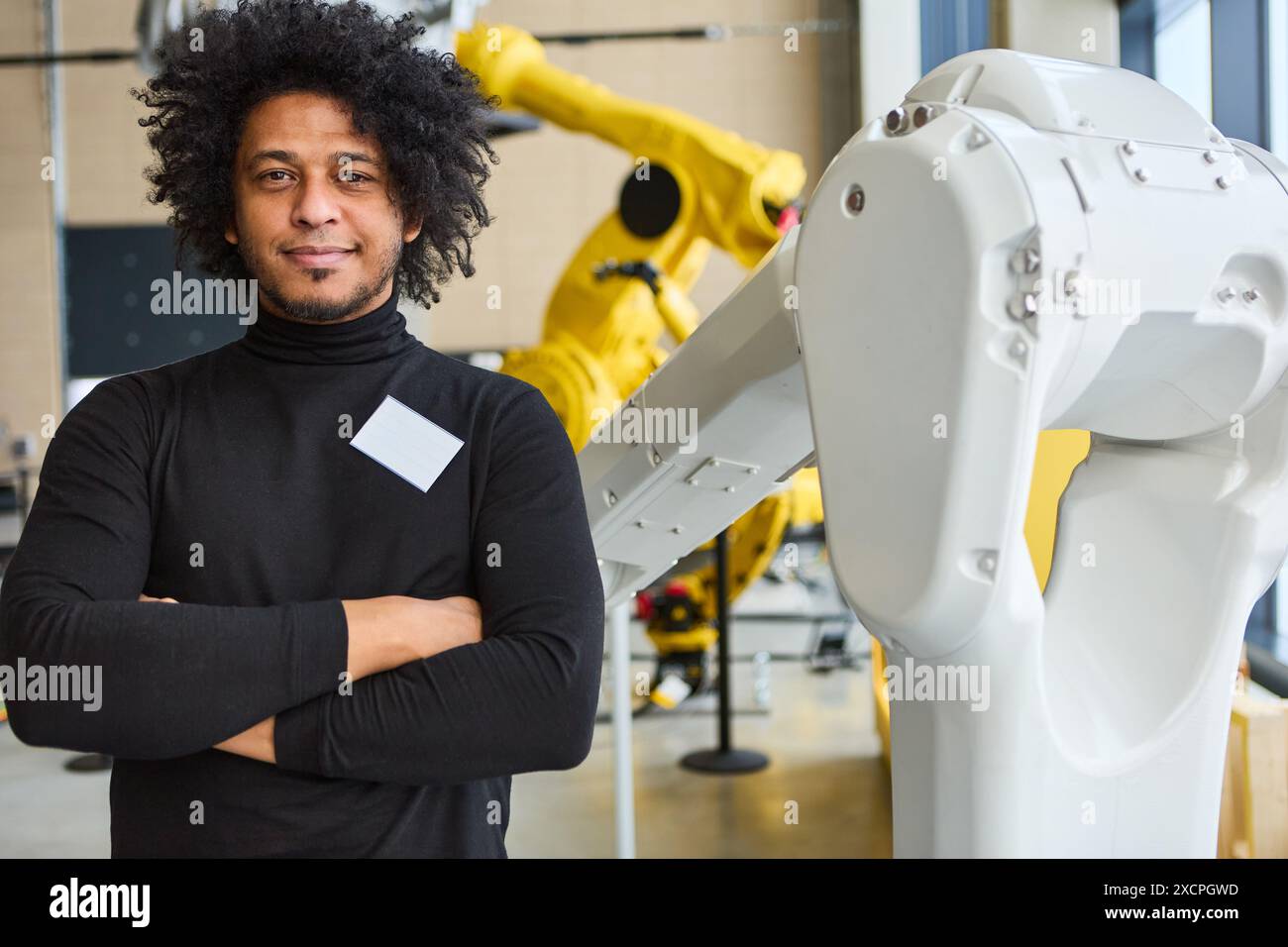 Ingegnere del laboratorio robotico che lavora con bracci robotici multiuso avanzati progettati per l'automazione industriale, la formazione, l'ispezione e la produzione Foto Stock