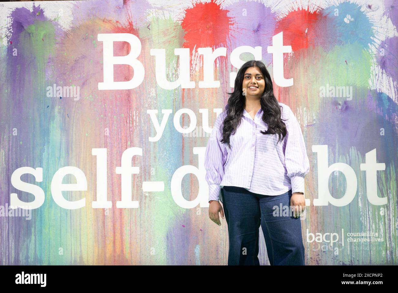 SOLO PER USO EDITORIALE Henna Mistry contribuisce a un'installazione artistica interattiva della British Association for Counselling and Psychotherapy (BACP) al di fuori della Battersea Power Station di Londra, come parte di una campagna per evidenziare come la terapia può aiutare a risolvere i problemi legati al dubbio di sé affrontati dalle donne. Data foto: Martedì 18 giugno 2024. Foto Stock