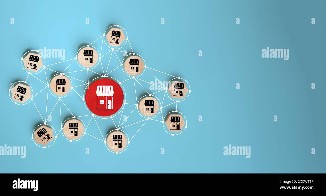 Concetto aziendale di franchising. blocchi di legno con una rete di icone di negozi connessi per l'e-commerce aziendale in franchising e-marketplace online e mar digitale Foto Stock