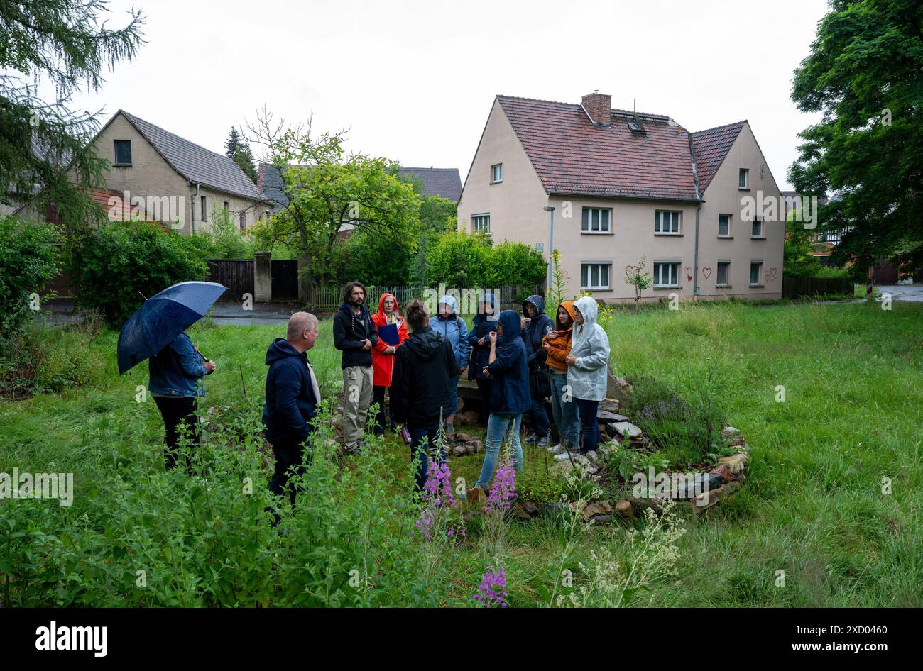 19 giugno 2024, Sassonia, Pödelwitz: I membri di un comitato di valutazione per il concorso "il nostro villaggio ha un futuro" visitano il villaggio di Pödelwitz. Qualche anno fa, il destino del villaggio nell'area mineraria della lignite sembrava sigillato. Pödelwitz doveva essere estratta. La salvezza è arrivata nel 2021. Ora il villaggio sta facendo domanda per il concorso statale organizzato dal Ministero sassone per lo sviluppo regionale. Solo 33 persone vivono ancora nel villaggio, il 80% delle case sono vuote e abbandonate dal 2015/16. I lotti di terreno appartengono a Mibrag, la compagnia mineraria una volta li acquistò dai residenti di Pödelwitz Foto Stock