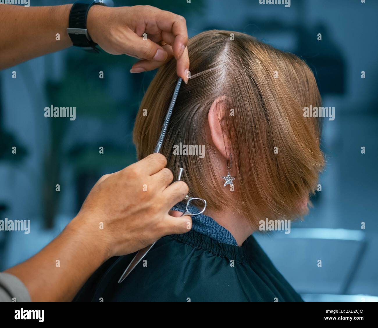 Le mani del parrucchiere tagliano i capelli. Parrucchiere che taglia i capelli della donna. donna tagliata i capelli. Salone di parrucchiere. Taglio di capelli femminili. Primo piano del taglio dei capelli. Professione Foto Stock