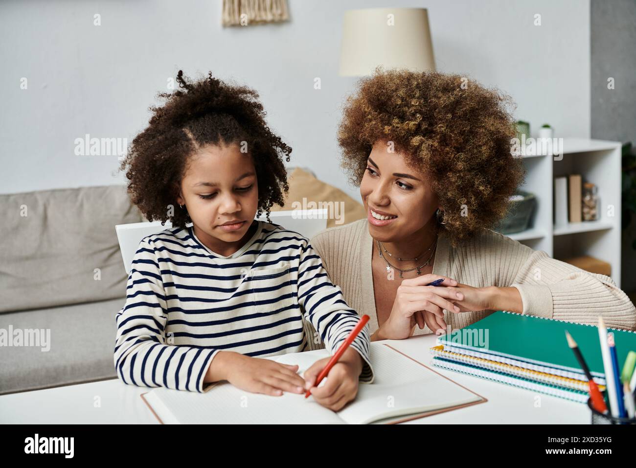 Madre e figlia afroamericana si impegnarono in attività accademiche insieme a casa. Foto Stock