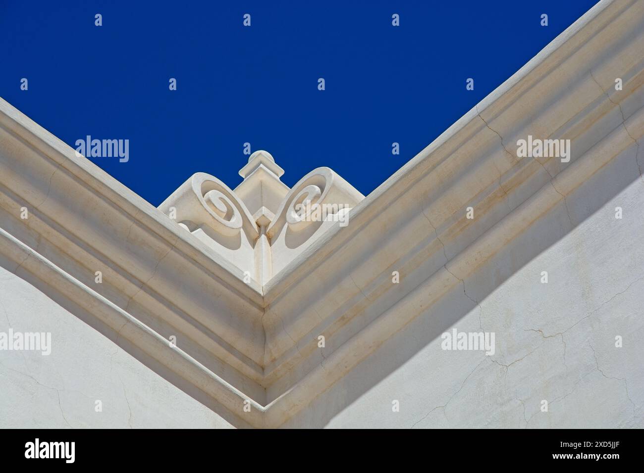 Dettaglio di cornici decorate in stile coloniale spagnolo sulla linea del tetto adagiata su un cielo blu luminoso Foto Stock