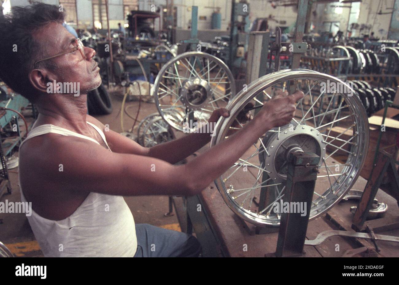 Lavoratore alla fabbrica motociclistica di Royal Enfield a Chennai, nella provincia Tamil Nadu in India. India, Chennai, aprile 1998 Foto Stock