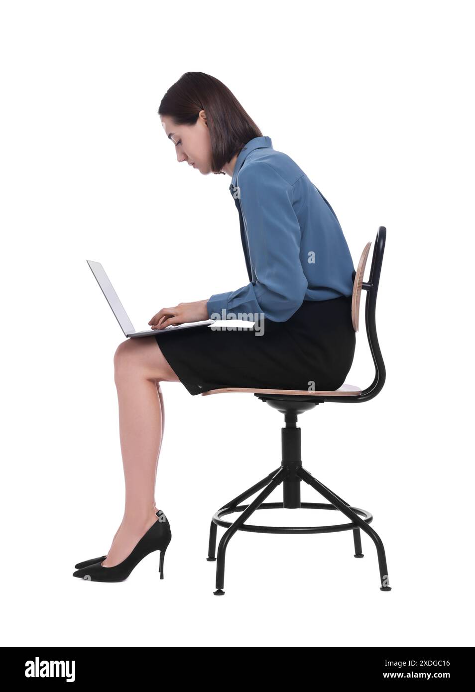 Donna con postura scarsa seduta su una sedia e che utilizza un computer portatile su sfondo bianco Foto Stock