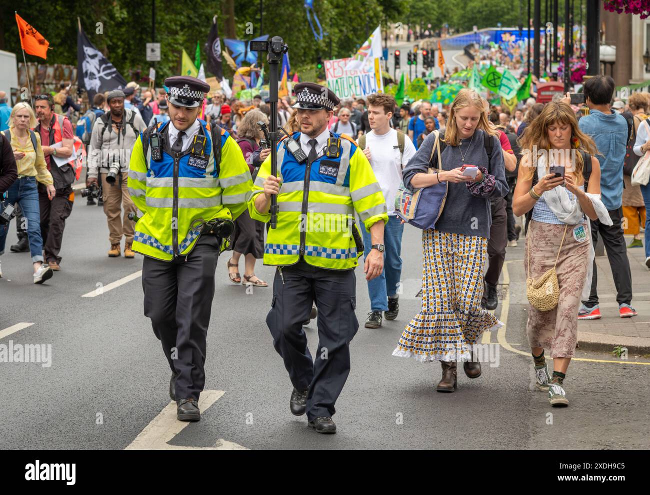 Londra Regno Unito - 22 giugno 2024: Due agenti della polizia metropolitana portano una videocamera per registrare la dimostrazione di Restore Nature Now a Londra, Regno Unito Foto Stock