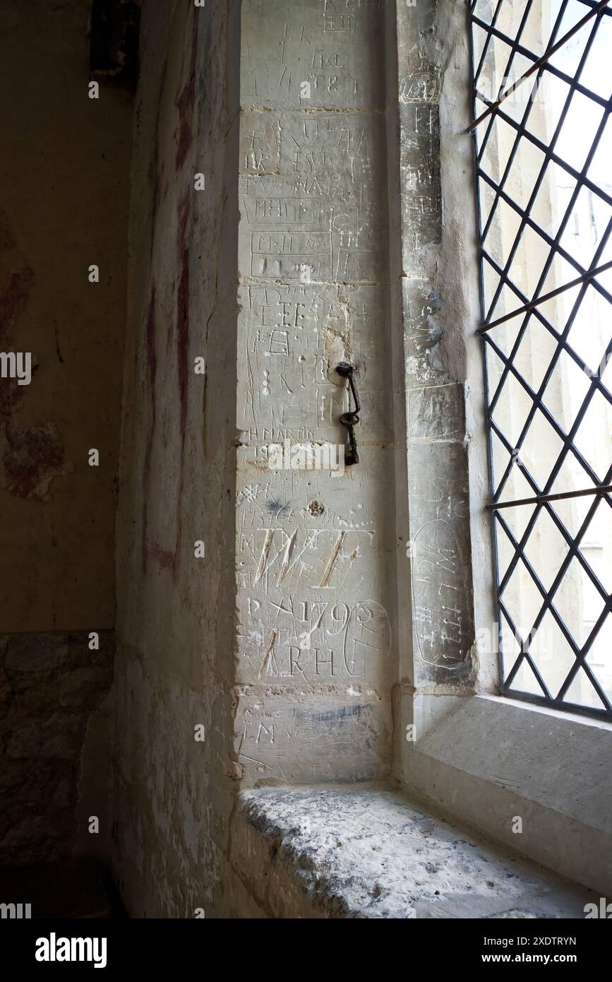Vandalismo storico accanto a una finestra in tutti i Santi e Chiesa di Sant'Andrea a Kingston, Cambridgeshire Foto Stock