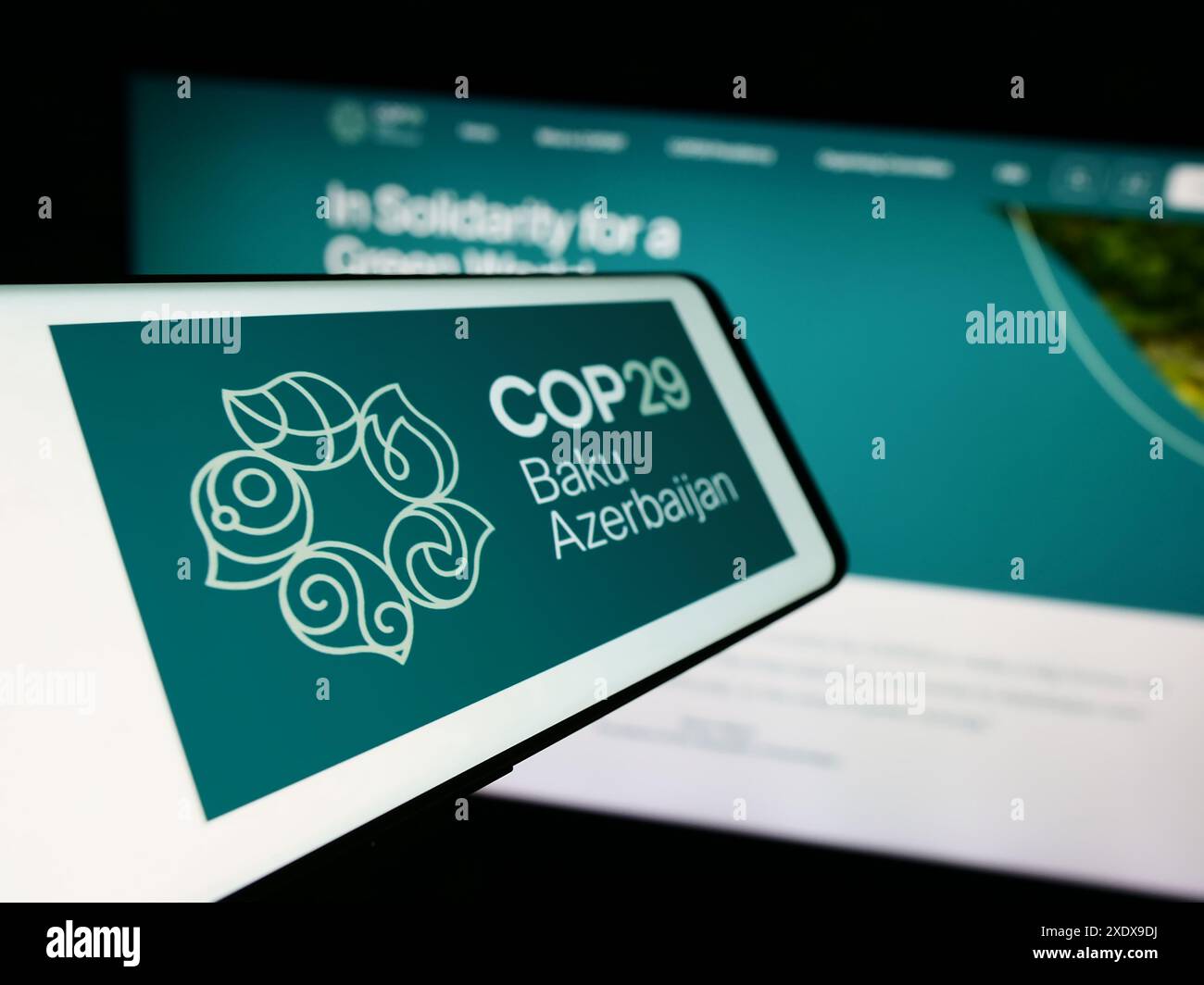 Cellulare con logo della Conferenza delle Nazioni Unite sui cambiamenti climatici 2024 COP29 davanti al sito web. Mettere a fuoco la parte sinistra del display del telefono. Foto Stock