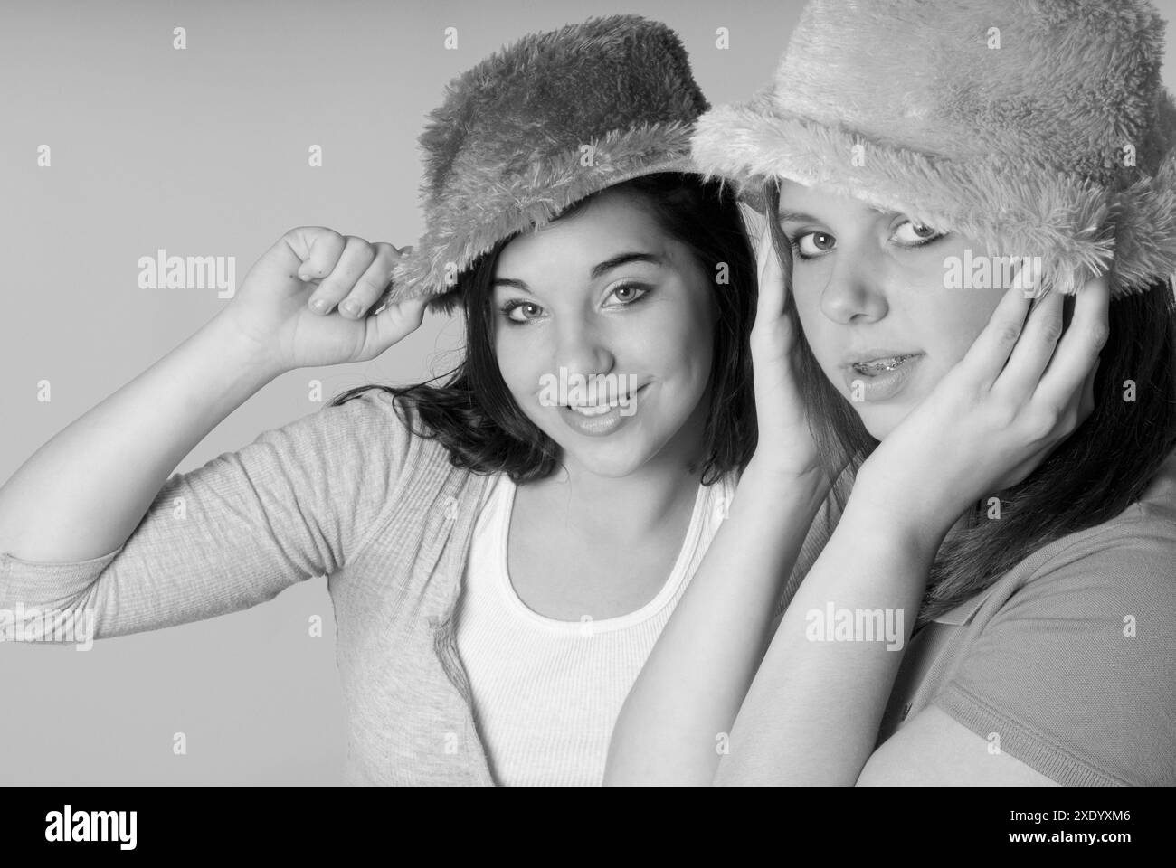 Due ragazze caucasiche che indossano cappelli colorati e sorridono. STATI UNITI Foto Stock