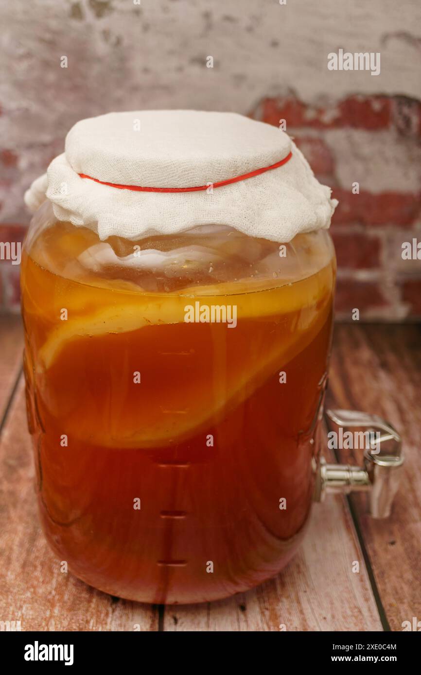 Bevanda fatta in casa con tè fermentato kombucha in vaso con rubinetto Foto Stock