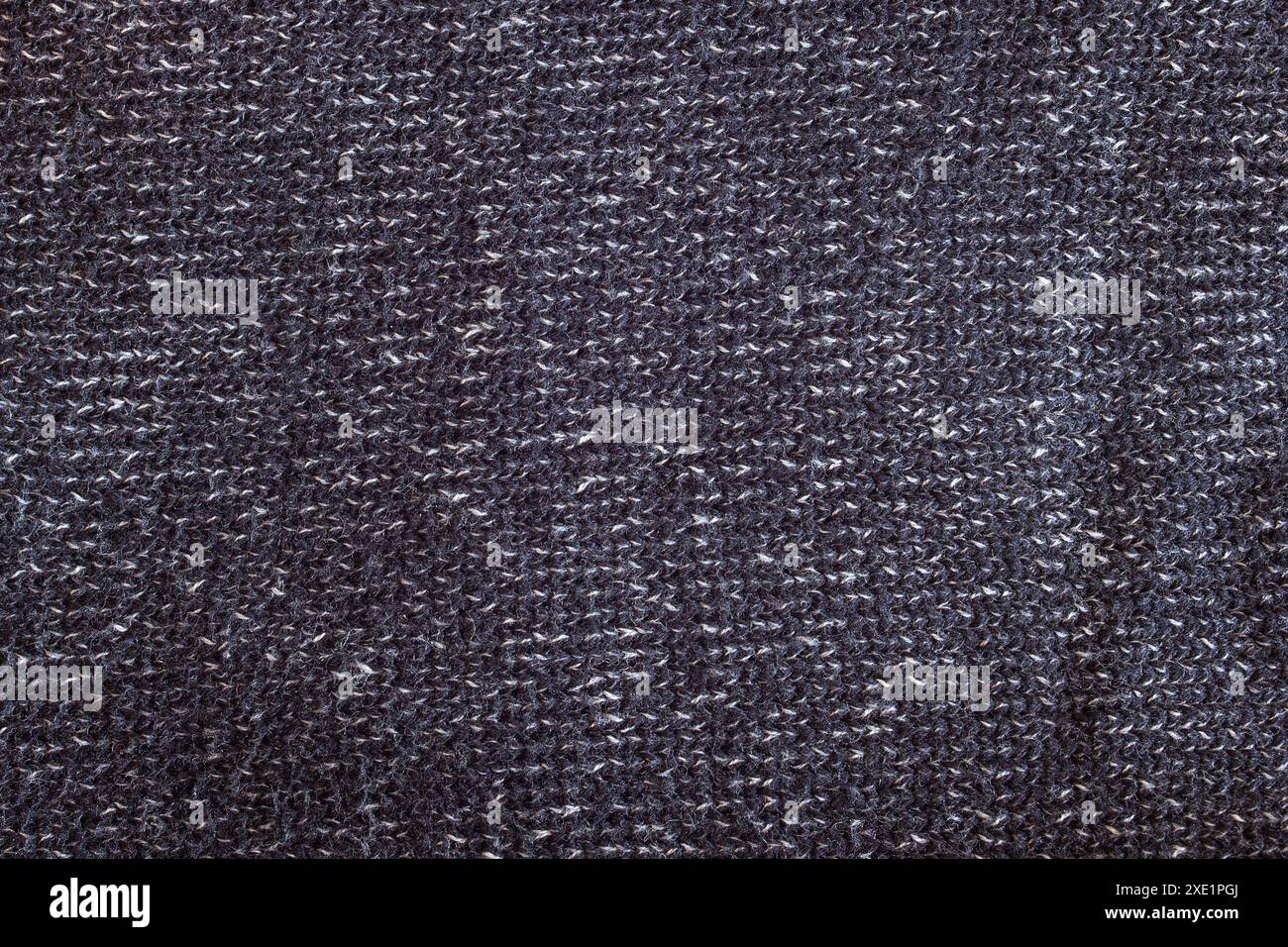 Il primo piano di un motivo a trama di twill e l'interazione di fili scuri e chiari mostrano la combinazione di materiali come cotone e acrilico come unione Foto Stock