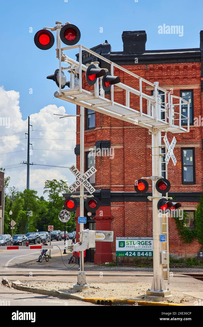 Railway Crossing Signal e vista panoramica dello storico edificio in mattoni Foto Stock