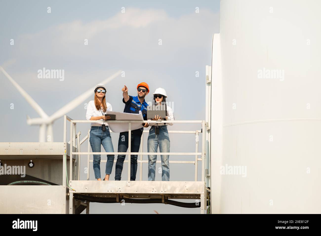 Un gruppo di ingegneri e architetti lavora sul pavimento di base di una turbina eolica Foto Stock Un gruppo di ingegneri e architetti lavora sul pavimento di base di una turbina eolica Foto Stock