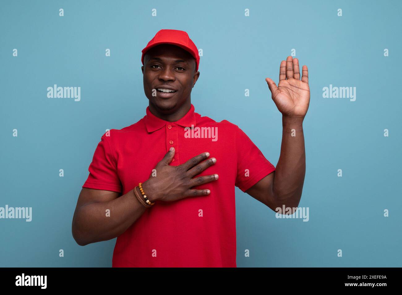 Colore aziendale. uomo americano con t-shirt rossa e berretto sullo sfondo con spazio per le copie Foto Stock