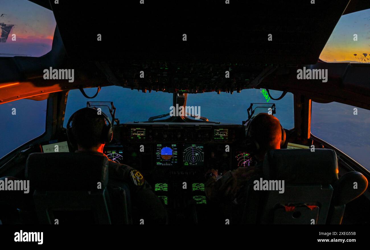 Da sinistra, il capitano Matt Slater e il capitano Patrick Mohr, piloti del 15th Airlift Squadron, pilotano un C-17 Globemaster III durante un'operazione di addestramento notturno sulla costa della Carolina del Sud, il 26 giugno 2024. I membri dell’equipaggio conducono regolarmente operazioni di addestramento durante la notte per mantenere la prontezza e la competenza in ambienti difficili. (Foto U.S. Air Force di Christian Silvera, Senior Airman) Foto Stock