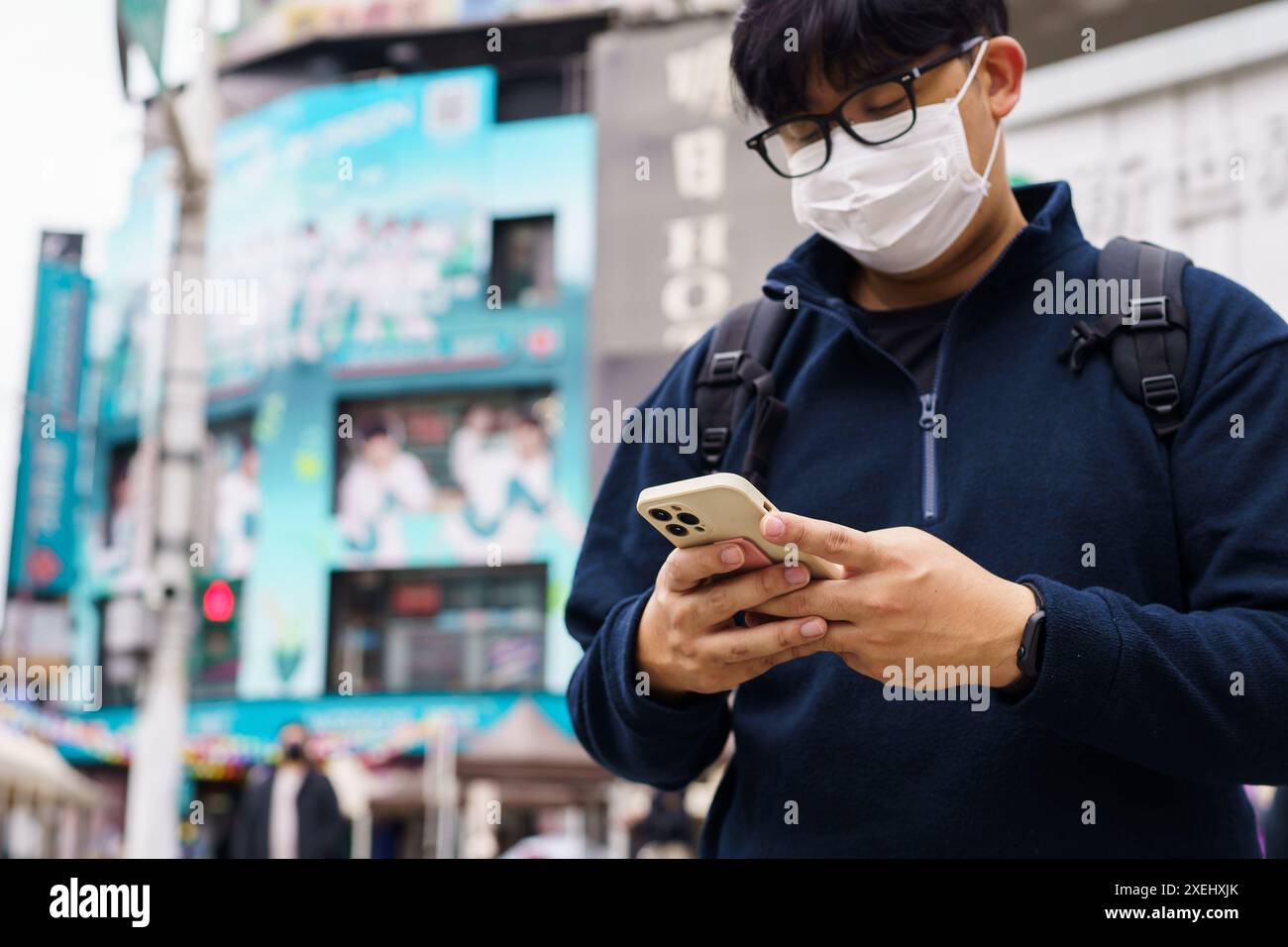 Uomo in centro città che ordina taxi utilizzando l'app per smartphone che prenota taxi utilizzando l'applicazione online sullo smartphone Foto Stock