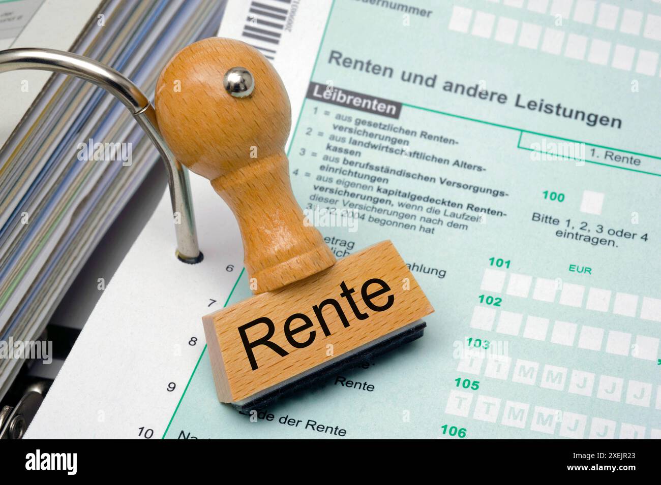 Rentenbesteuerung Ein Holzstempel mit Aufschrift RENTE liegt auf dem formular einer Steuererklärung *** Pension tax Un timbro in legno con l'inscr Foto Stock