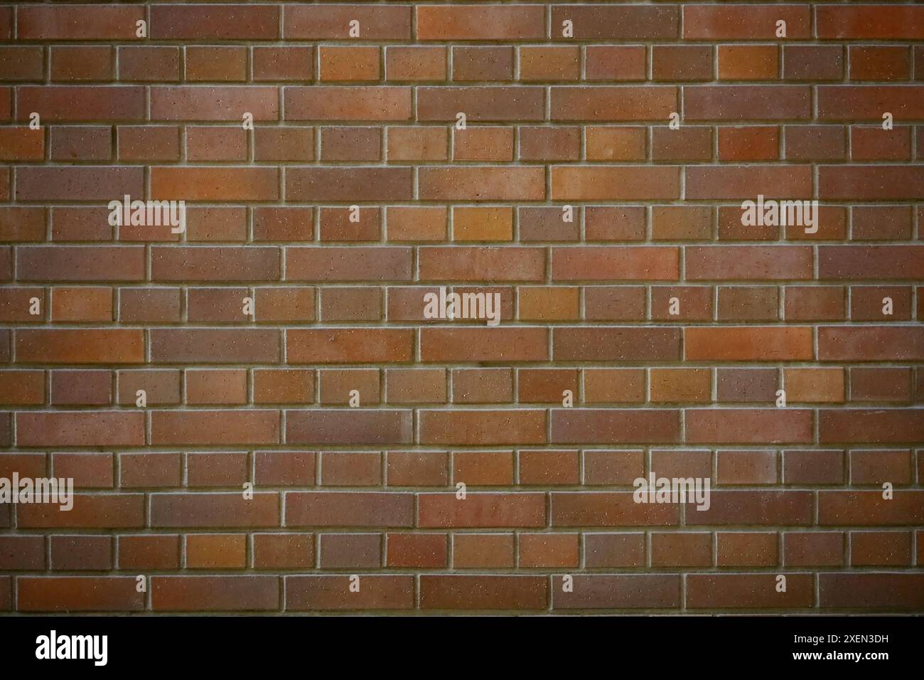 Una foto di un muro di mattoni rossi come materiale di sfondo Foto Stock