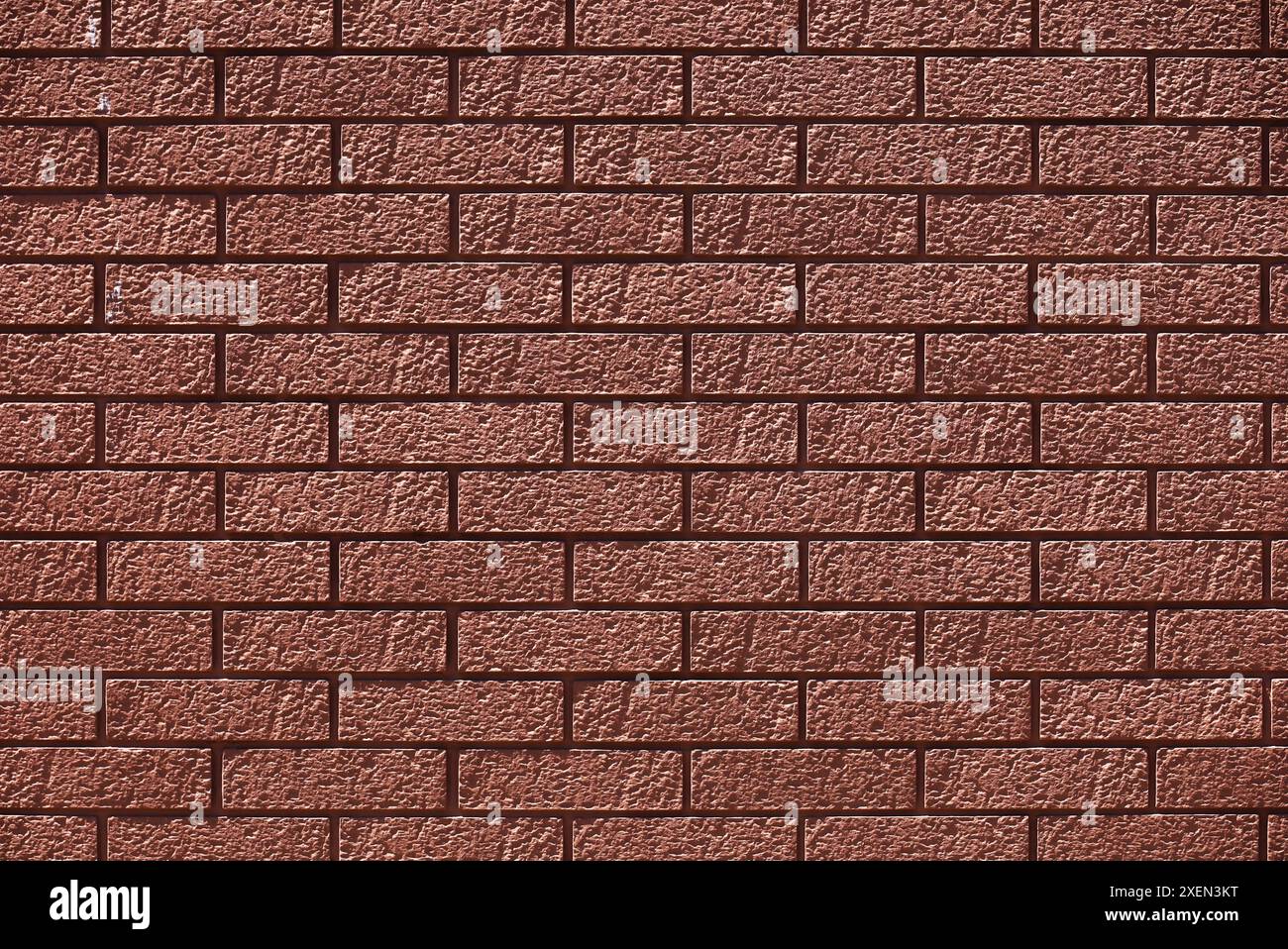 Una foto di un muro di mattoni rossi come materiale di sfondo Foto Stock